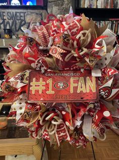 a football wreath with the number 1 fan on it in front of a bookshelf