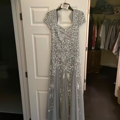 a dress hanging on a door in front of a closet