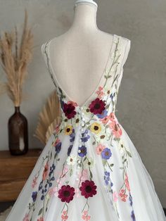 a dress on a mannequin with flowers all over it