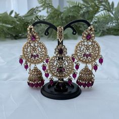 Kundan jewelry set includes a pair of earrings and a tikka. Colour: purple/plum Festive Bollywood Purple Jewelry, Festive Purple Bollywood Jewelry, Purple Kundan Jewelry For Diwali, Festive Purple Kundan Earrings, Purple Kundan Earrings For Wedding, Traditional Kundan Purple Earrings, Traditional Purple Kundan Earrings, Purple Jewelry For Wedding On Diwali, Purple Jewelry For Wedding And Diwali