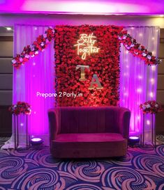 the stage is decorated with flowers and candles for an elegant function in red, white and purple