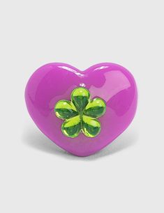 a purple heart shaped object with green flowers on the front and sides, against a white background