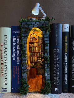 a book shelf with several books and a lamp on top of it next to some books