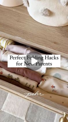 an open drawer with folded fabric in it and the words perfect folding hacks for ne - parents