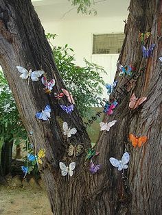 several butterflies are attached to the bark of a tree