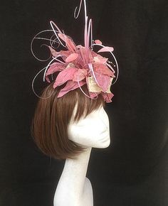 Pink and ivory flower fascinator. Wonderfully wild collection of heat treated fabrics including silks, nylons and satins teamed with synthetic grasses and scattered crystals. This design is the perfect combination of many textures and a wonderful example of how many different textile methods can be grouped together to produce the most wonderful creation. This design is set onto a fine comfort fascinator band. As with all our designs, this piece can be made exact to the image or in any colour com Whimsical Pink Headpiece With Handmade Flowers, Whimsical Pink Headband With Handmade Flowers, Pink Flower Headband With Handmade Flowers, Whimsical Pink Hair Accessories With Handmade Flowers, Pink Party Headpiece With Flower Decoration, Elegant Pink Hair Accessories For Royal Ascot, Whimsical Pink Headband Fascinator, Pink Flower Headpiece For Kentucky Derby, Whimsical Pink Headband For Wedding