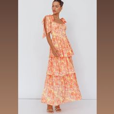 This Is A Beautiful Orange, Floral Summer Dress That Gives A Feminine Flare. It's A Perfect Dress For A Garden Party, A Wedding, Or Just A Summer Photoshoot. The Fabric Is Gorgeous And Light. Feminine Yellow Tiered Dress, Orange Tiered Dress For Day Out, Orange Tiered Dress For Brunch, Orange Feminine Maxi Dress For Brunch, Feminine Orange Dress For Vacation, Feminine Orange Vacation Dresses, Feminine Orange Dress For Day Out, Light Orange Bridesmaid Dresses, Pastel Orange Dress