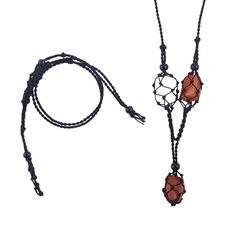 an orange and black beaded necklace with two beads on the end, hanging from a cord