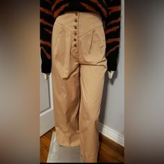 Elevate Your Wardrobe With These Chic Gianni Bini Khaki Chino Pants. The Pleated Front And Wide-Leg Style Add A Touch Of Sophistication, While The High-Rise Waist And Button Closure Provide A Comfortable And Secure Fit. With Pockets For Added Convenience, These Pants Are Perfect For Any Occasion. Crafted With Care And Machine Washable For Easy Maintenance, These Pants Are A Must-Have For Any Fashion-Forward Woman. Available In Beige Color, These Pants Are Sure To Complement Any Personal Style. I Chic Brown Button-up Bottoms, Button Zip Fly Straight Pants, Wide Leg Pants With Button Closure For Office, Casual Office Pants With Buttons, Chic High Waist Wide Leg Pants With Buttons, Chic High-waisted Wide Leg Pants With Buttons, Trendy High Waist Wide Leg Pants With Button Closure, Casual Fitted Wide Leg Pants With Button Closure, Fitted Wide Leg Pants With Button Closure