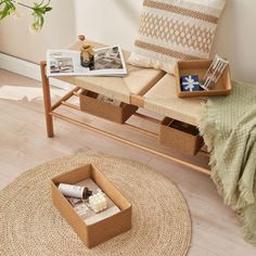 a wooden bench sitting on top of a hard wood floor next to a basket filled with items