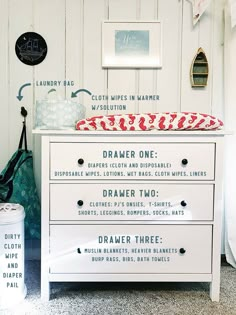 a white dresser sitting next to a wall