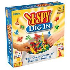 the box for spy dig in is filled with colorful plastic objects and hands reaching into it