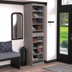 a room with a bench, mirror and shoes on the shelves next to a door