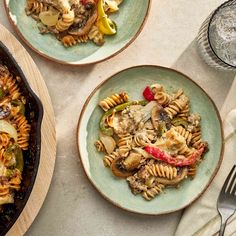 three plates with pasta and vegetables on them