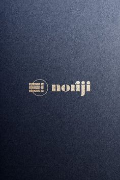 the logo for an electronic device is shown on a black paper with gold foil lettering