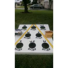 a white board game set up in the grass