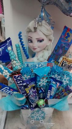 a frozen princess bouquet with candy, candies and other items in the vase for someone's birthday