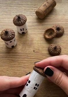 a person is holding a cork with some sort of house on it and other things around them