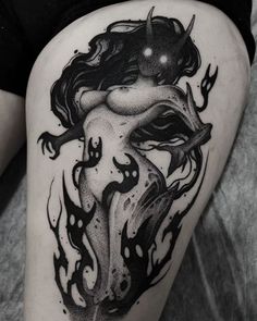 a woman's thigh with black and white tattoos on it