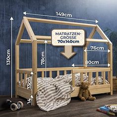 a wooden bed frame with measurements for the size and width of it, next to a teddy bear