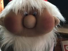 a close up of a stuffed animal wearing a santa hat