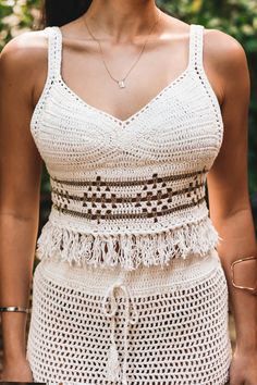 Obsessing over the Izzy crochet top! We're planning our next vacation just to wear this outfit! Mix & Match with your favorite bottoms for summer jeans or shorts! Color: Natural with gold detail Crochet Small V neck cami scalloped trim hem Lined in all the right areas Can be worn without a bra(closed stitch) Not sheer in the front Tassel trim detail Back button closure Runs small, model is wearing M Model is wearing a size Medium. She is 5'5". 124 lbs. Bust: 32C Waist 26" Hips 36 1/2 Chic Crochet Lace Crop Top For Vacation, Chic Crochet Crop Top For Vacation, Chic Cotton Crochet Top For Vacation, Beachy Crochet Top For Summer Day Out, Chic Crop Top With Crochet Trim For Beach, Chic Crochet Lace Crop Top For The Beach, Chic Cotton Crochet Beach Top, Summer Tank Top With Crochet Trim For Day Out, Summer Vacation Crop Top With Crochet Trim