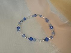 A luxurious, eye-catching, handmade stretch bracelet made using high-quality, lead-free, glass-cut crystals - made in the Czech Republic - renowned for their superior level of sparkle and brilliance.  Your something blue for your wedding day * This bracelet is so sparkly & will be sure to draw attention. The bracelet looks beautiful either on its own or stacked with others. The bicone shape, paired with the variety of finishes on the beads create a unique and super sparkly effect. This bracelet Elegant Blue Hand-strung Crystal Bracelet, Elegant Blue Stretch Bracelet With Faceted Beads, Blue Round Bead Bracelets For Weddings, Blue Round Beads Bracelet For Wedding, Handmade Blue Crystal Beaded Bracelets, Blue Beaded Rondelle Crystal Bracelet, Blue Czech Glass Bracelet With Spacer Beads, Adjustable Blue Crystal Bracelet For Wedding, Blue Beaded Bracelets For Weddings