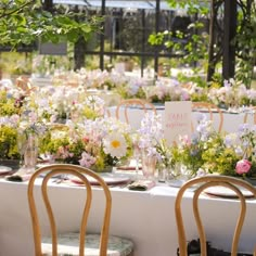 a table set up with flowers and place cards