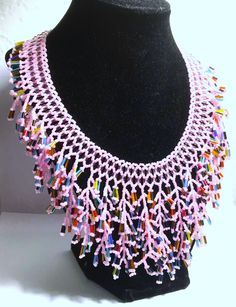 A handmade glass beaded necklace that is perfect for any occasion: parties, holidays, birthdays, anniversaries. All products are hand-crafted by my mother. Dimensions: - Actual Length: 30.0 cm - Collar Length: 22.0 cm - Width: 14.0 cm - Height: 2.0 cm Lightweight, high quality with a beaded toggle as a clasp. Will respond to concerns and suggestions promptly. Acrylic Pearls: 8 mm. Shipping costs: Free Domestic Shipping. All orders are sent by air-mail with tracking number. Time of delivery: Estimated 1-3 days for domestic shipping; international make take 7-14 days. Feel free to check out our other similiar products! Link: https://www.etsy.com/shop/NurKnitsNKrafts Pink Beaded Necklaces With Round Beads For Crafting, Glass Beaded Necklaces With Dangling Beads As Gifts, Adjustable Glass Beaded Necklaces With Dangling Beads, Adjustable Glass Beaded Necklace With Dangling Beads, Handmade Artisan Glass Beaded Necklaces, Adjustable Colorful Beads Necklace For Celebration, Adjustable Colorful Beaded Necklaces For Celebration, Handmade Glass Bead Necklaces, Handmade Beaded Necklaces With Round Beads For Celebration