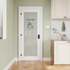 a kitchen with green walls and white cabinets