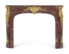 a marble fireplace surround with gold leaf decorations on the top and bottom, along with an ornately carved design