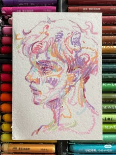 a drawing of a woman's face with colored crayons in the background