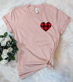 Looking for that perfect and cute Valentine's Day shirt? Then this Plaid Heart pocket print design is the perfect tee Trendy Cotton T-shirt For Valentine's Day, Cute T-shirt With Heart Graphic, Cute Short Sleeve T-shirt With Heart Graphic, Pink Heart-shaped Graphic Print T-shirt, Trendy T-shirt With Heart Graphic For Everyday, Cute Heart-shaped Cotton T-shirt, Cute Cotton T-shirt With Heart Graphic, Cute Cotton T-shirt With Heart Design, Cute Cotton T-shirt With Heart Shape