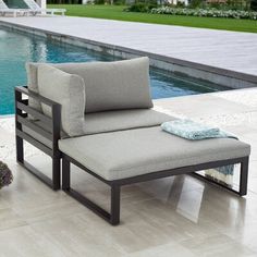 an outdoor chaise lounge chair next to a swimming pool