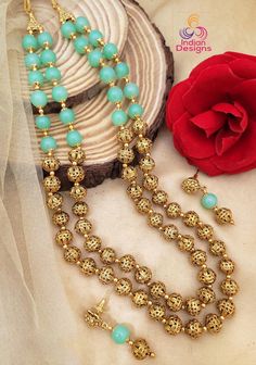 Add a touch of color to your daily wear with this Handcrafted Golden Bead Mala! These handmade Golden bead mala consists of 22K Gold plated beads with unique floral design. The Two layer mala has been strung together and attached to the string of color jades which pair well with matching earrings. Length of the necklace is 22 inches and + Adjustable Thread extender Earrings length is 1.75 inches Fusion Style Gold Beaded Necklaces, Traditional Gold Beaded Necklaces With 8mm Beads, Gold Round Beads Fusion Necklace, Gold Fusion Beaded Necklaces With Round Beads, Festive 8mm Round Bead Necklace, Festive Gold Beaded Chain, Fusion Style Beaded Necklaces With Round Beads For Gifts, Traditional Festive Jewelry With 8mm Beads, Festive Beaded Necklaces