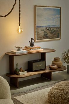 a living room with a couch, table and pictures on the wall