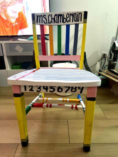 a chair made out of crayons is sitting on the floor