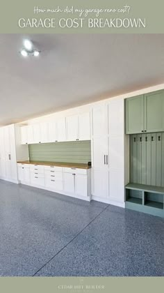 an empty garage with white cabinets and drawers