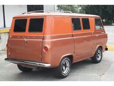 an orange van parked in a parking lot