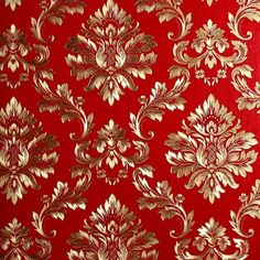 a red and gold wallpaper with ornate designs