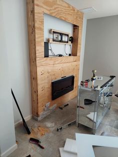 a room that is being remodeled with wood on the wall and other items around it