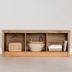 a wooden shelf with baskets and books on it