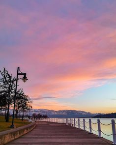 a pier with a light pole and some trees