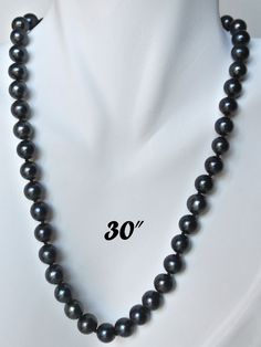 "PREMIUM ROUND 9-9.5mm BLACK PEARL NECKLACE Elegant Round shaped black cultured freshwater pearl necklace; Handpicked by experienced jewelers for their luster, color and cleanliness; Available in other pearl sizes (6mm to 12mm) and other colors (white, peach). EXQUISITE CRAFTSMANSHIP Carefully double knotted between each pearl; Finished with sturdy rose-shaped clasps; This fine pearl jewelry is a symbol of wisdom and is believed to offer protection and attracts good luck and wealth. LUXURY JEWEL Pearl Strands Necklace, Black Pearl Necklace, Pearls Jewelry, Pearl Strand, Necklace Clasps, Jewelry Men, Pearl Strands, Pearl Set, Black Necklace