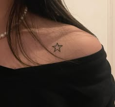 a woman with a small star tattoo on her chest