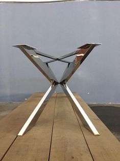 a metal sculpture sitting on top of a wooden table