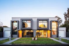 a modern house with three stories and lots of windows