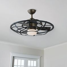 a ceiling fan with two lights on top of it in front of a white wall