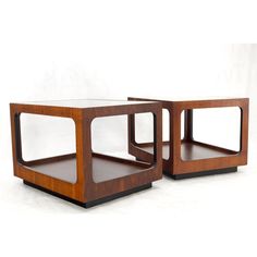 two wooden side tables sitting next to each other on top of a white flooring