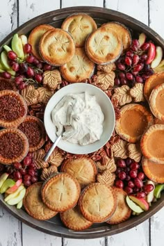 a platter filled with pies, crackers and fruit